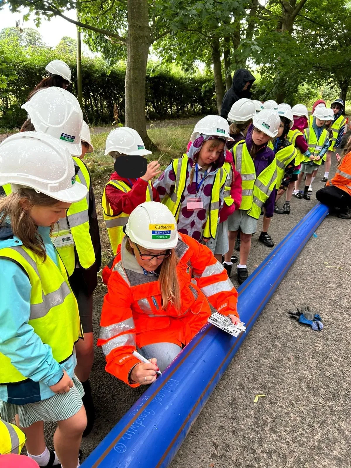 Heartland community work with school children signing pipe