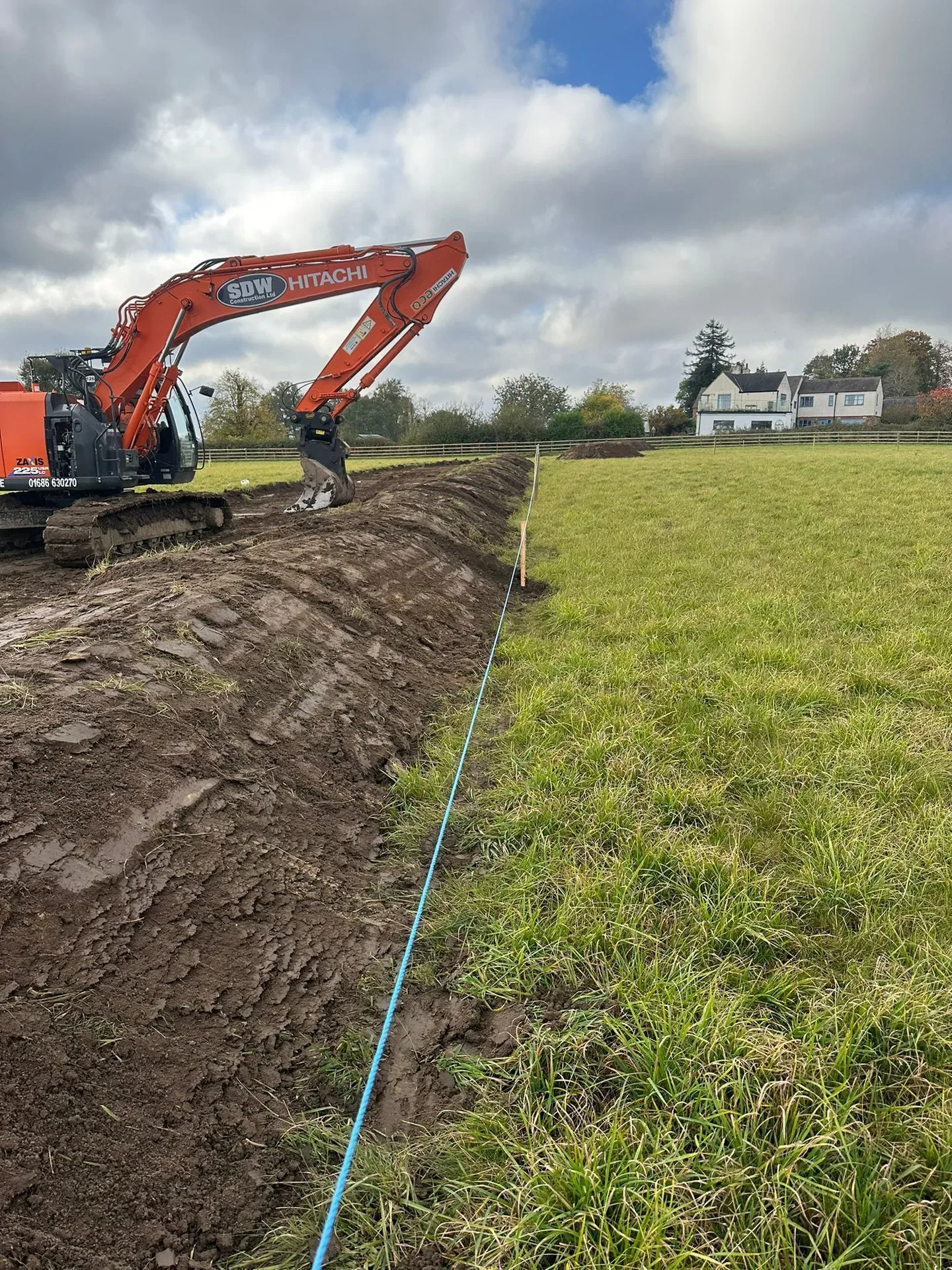 Utility installation digger covering pipe